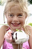 Blond girl with a mixed ice cream sundae