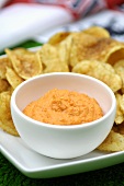 Red pepper dip with potato crisps