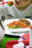 Green ribbon pasta with tomato sauce and burgers