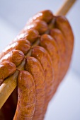 Polish sausages hanging on a wooden rail