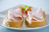 Two slices of bread and ham on a plate