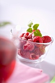 Fresh raspberries in a small glass dish