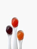 Cocktails on spoons: creme de cassis, blood-orange juice and Aperol with orange juice (molecular gastronomy)