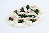 Uncooked tarte flambée with trout and spinach