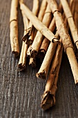 Cinnamon sticks on a wooden surface (close up)