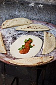 Tortilla with bean sauce and coriander