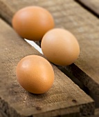 Three eggs on a wooden crate