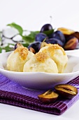 Potato dumplings with plums and buttered crumbs