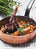 A joint of lamb braised in red wine with vegetables