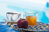 Coffee, orange juice and a peach for breakfast