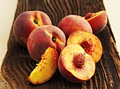 Yellow-flesh peaches on a wooden surface