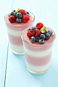 Layered dessert with yogurt, raspberry mousse and berries