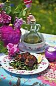 Crispy chicken with char and raisins on a garden table