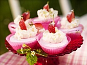 Pink meringue cakes with whipped cream and strawberries