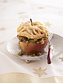 A baked apple with a pistachio-date filling and a dough lid