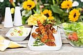 Grilled kebabs with thyme and a side salad
