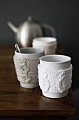 Tea cups with knitted cup warmers