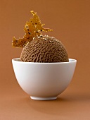 Chocolate ice cream with caramel in white bowl