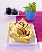 Two plum and ricotta puff pastry tarts