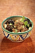 Lamb tajine with prunes in a patterned bowl