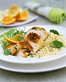 Roast chicken breast with orange sauce on couscous