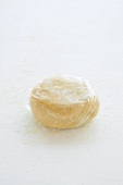 Ball of shortcrust pastry wrapped in cling film