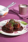 Three figs poached in red wine and blackberry sauce