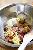 Raw diced beef with spices in a bowl ready for marinating