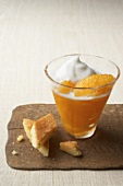 Orange segments with amaretto foam in glass, almond sponge