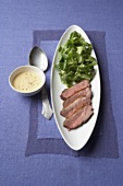 Slices of duck breast with corn salad