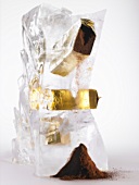 Ground coffee in a block of ice trickling out of packet