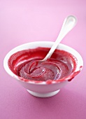 Home-made cranberry sauce in a dish with a spoon