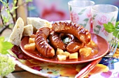 Grilled sausages on apricot and pineapple compote