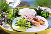 Grilled salmon steak with herbs on a tray