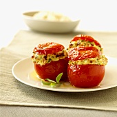 Three tomatoes stuffed with cheese, bacon and leeks