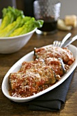 Aubergine rolls with minced lamb filling in tomato sauce