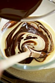 Mixing melted chocolate and custard in a bowl