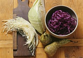 Shredded red and white cabbage and whole pears