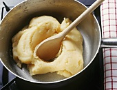 Stirring choux pastry mixture over heat (making profiteroles)