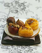 Two small chocolate orange cakes with figs on a plate