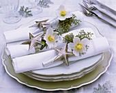 Napkins decorated with Christmas roses, cypress and stars