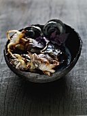 Grilled squid with ink in a wooden bowl