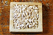 Pieces of white peony root on a stone slab