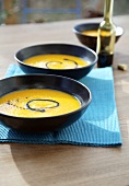 Pumpkin & apple soup with pumpkin seed oil in three dishes