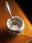 Coarse sea salt in a small pot with a spoon