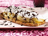 Poached pears and soft cheese on slice of toast