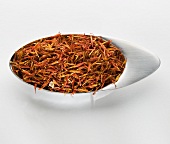 Saffron threads in a small metal dish
