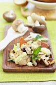 Raclette with mushrooms and ham on a wooden board
