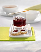 Cherry jam in a glass with jam biscuits (Christmas)