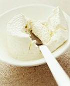 Ricotta in a dish with a knife